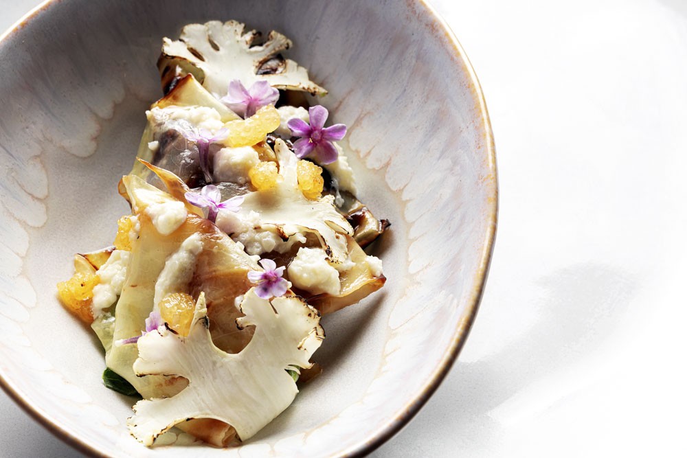 Cabbage on fire with cauliflower puree and topped with butter sauce